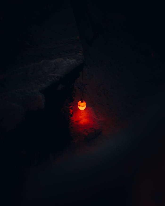 A mysterious red glow in the dark, creating an eerie nighttime atmosphere.